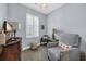 This room features a gray chair, gray walls, a tv, and a window with white shutters at 1352 Jolly Roger Dr., North Myrtle Beach, SC 29582