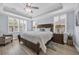 Inviting main bedroom with a large bed, wood furnishings, lots of natural light and tray ceilings at 1352 Jolly Roger Dr., North Myrtle Beach, SC 29582