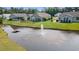 Aerial view of a community lake with a fountain and adjacent houses at 1407 Sunningdale Ln., Myrtle Beach, SC 29588
