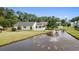 Aerial view of the backyard featuring a white picket fence, patio, and lake with a fountain at 1407 Sunningdale Ln., Myrtle Beach, SC 29588