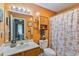 The bathroom has orange walls, sink, toilet, and a starfish themed shower curtain at 1407 Sunningdale Ln., Myrtle Beach, SC 29588