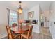 Well-lit dining space with an adjacent bar counter, a round wooden table and large window views at 1407 Sunningdale Ln., Myrtle Beach, SC 29588