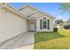 Inviting front of home with manicured lawn, trimmed bushes, and yellow siding at 1407 Sunningdale Ln., Myrtle Beach, SC 29588
