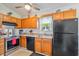Bright, sunny kitchen with updated appliances, breakfast bar, and wood cabinets at 1407 Sunningdale Ln., Myrtle Beach, SC 29588
