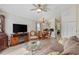 Open-concept living and dining area with a cozy sofa and a stylish entertainment center at 1407 Sunningdale Ln., Myrtle Beach, SC 29588