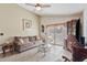 Bright living room with access to the outdoor patio, a glass coffee table, and a vintage hutch at 1407 Sunningdale Ln., Myrtle Beach, SC 29588