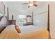 Spacious main bedroom with a four-poster bed, ample closet space, and a bright window at 1407 Sunningdale Ln., Myrtle Beach, SC 29588