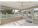 Bright screened-in porch with tile flooring, ceiling fan, and views of the backyard at 1407 Sunningdale Ln., Myrtle Beach, SC 29588