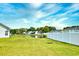 A well-maintained backyard with a pond view, secured by a white fence, providing a serene outdoor space at 1412 Reid Ct., Myrtle Beach, SC 29588