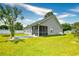 A screened-in porch with an outdoor patio offers a relaxing view of the backyard's well-manicured lawn at 1412 Reid Ct., Myrtle Beach, SC 29588