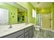 Bright bathroom features double vanity, shower stall, and green decor at 1412 Reid Ct., Myrtle Beach, SC 29588