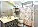 Well-maintained bathroom with charming nautical-themed shower curtain and wood flooring at 1412 Reid Ct., Myrtle Beach, SC 29588