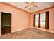 Bright bedroom boasts two windows, carpet and ceiling fan; doorways to other rooms are visible at 1412 Reid Ct., Myrtle Beach, SC 29588