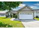 Charming home featuring a two-car garage and landscaped front yard at 1412 Reid Ct., Myrtle Beach, SC 29588
