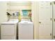 Functional laundry room with washer, dryer, shelving for storage, and convenient access door at 1412 Reid Ct., Myrtle Beach, SC 29588