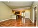 Open-concept living room with wood floors, leading to the kitchen and entryway at 1412 Reid Ct., Myrtle Beach, SC 29588
