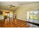 Open-concept living room with wood floors, leading to the kitchen and a sliding door at 1412 Reid Ct., Myrtle Beach, SC 29588