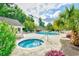 This community pool area features two pools, lounge chairs and tables, surrounded by tropical greenery at 1412 Reid Ct., Myrtle Beach, SC 29588
