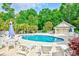 Community pool with lounge chairs, tables and umbrellas offers a relaxing space for residents to enjoy at 1412 Reid Ct., Myrtle Beach, SC 29588