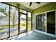 Inviting screened porch with views of the backyard, white fencing, and nearby houses at 1412 Reid Ct., Myrtle Beach, SC 29588
