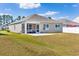 Charming screened-in porch extending to a concrete patio in a well-maintained yard at 142 Pine Forest Dr., Conway, SC 29526