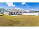 Spacious backyard with a screened-in porch, concrete patio, and partial white vinyl fence at 142 Pine Forest Dr., Conway, SC 29526