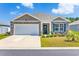 Charming single-story brick home featuring a well-manicured lawn, garage, and inviting front porch at 142 Pine Forest Dr., Conway, SC 29526