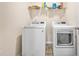 Bright laundry room features modern washer and dryer, and shelving at 142 Pine Forest Dr., Conway, SC 29526