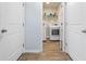 Bright laundry room features modern washer and dryer, shelving, and wood-look floors at 142 Pine Forest Dr., Conway, SC 29526