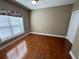 Bedroom featuring a ceiling fan, hardwood floors, and window with floral valance at 1428 Saint Thomas Circle # B-1, Myrtle Beach, SC 29577