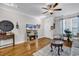 Cozy living room featuring hardwood floors, elegant decor, a ceiling fan, and a mirrored fireplace at 149 Ella Kinley Circle # 302, Myrtle Beach, SC 29588