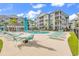 Exterior full view of the community pool area with lounge chairs, tables, and surrounding apartment buildings at 149 Ella Kinley Circle # 302, Myrtle Beach, SC 29588