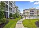 Landscaped walkway between modern apartments, leading to a community pool and recreation area at 149 Ella Kinley Circle # 302, Myrtle Beach, SC 29588