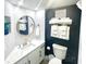 Modern bathroom with a white vanity, round mirror, and fresh towels at 161 Seawatch Dr. # 710, Myrtle Beach, SC 29572