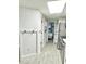 Hallway with white walls and floors leading to the bedroom and stainless steel appliances at 161 Seawatch Dr. # 710, Myrtle Beach, SC 29572