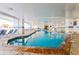 Bright indoor pool area with plenty of lounge chairs for residents and guests at 161 Seawatch Dr. # 710, Myrtle Beach, SC 29572
