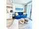 Bright living room featuring a blue sofa, coastal decor, and a sliding glass door to a balcony at 161 Seawatch Dr. # 710, Myrtle Beach, SC 29572