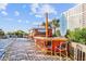 Exterior pool bar with palm trees, chairs and tables for visitors at 161 Seawatch Dr. # 710, Myrtle Beach, SC 29572