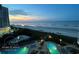 Oceanfront condo resort with swimming pools, jacuzzi, lush landscaping, and sunset sky at 161 Seawatch Dr. # 710, Myrtle Beach, SC 29572