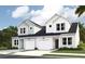 An inviting view of new two-story paired homes, each with an attached garage and lovely curb appeal at 1712 Hunting Harris Ct # 3, Ocean Isle Beach, NC 28469