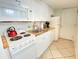 Compact kitchen features white cabinets, a stove, microwave, and refrigerator at 1805 Windmere W S Ocean Blvd. # 1109, Myrtle Beach, SC 29575