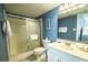 Bathroom with a spacious shower, blue accent wall, and modern sink at 1903 S Ocean Blvd. # 1110, North Myrtle Beach, SC 29582
