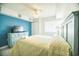 Cozy bedroom with blue accent wall and comfortable furnishings at 1903 S Ocean Blvd. # 1110, North Myrtle Beach, SC 29582