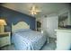 Well-lit bedroom with stylish blue accent wall and coastal themed decor at 1903 S Ocean Blvd. # 1110, North Myrtle Beach, SC 29582