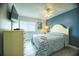 Inviting bedroom with stylish blue accent wall and coastal themed decor at 1903 S Ocean Blvd. # 1110, North Myrtle Beach, SC 29582