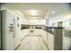 Bright kitchen features white cabinets, stainless steel appliances, and granite countertops at 1903 S Ocean Blvd. # 1110, North Myrtle Beach, SC 29582