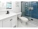Bathroom featuring a white vanity, toilet, and glass-enclosed shower with blue tile at 1931 Lakeview Circle, Surfside Beach, SC 29575