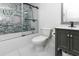 Bathroom showcasing a tub-shower with glass doors, gray marble wall tiles and a modern vanity at 1931 Lakeview Circle, Surfside Beach, SC 29575