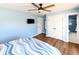 Light-filled bedroom with closet, TV and access to en-suite bathroom featuring blue tile at 1931 Lakeview Circle, Surfside Beach, SC 29575