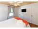 Bedroom with a queen bed, nightstands, wood floors, ceiling fan and bright window at 1931 Lakeview Circle, Surfside Beach, SC 29575